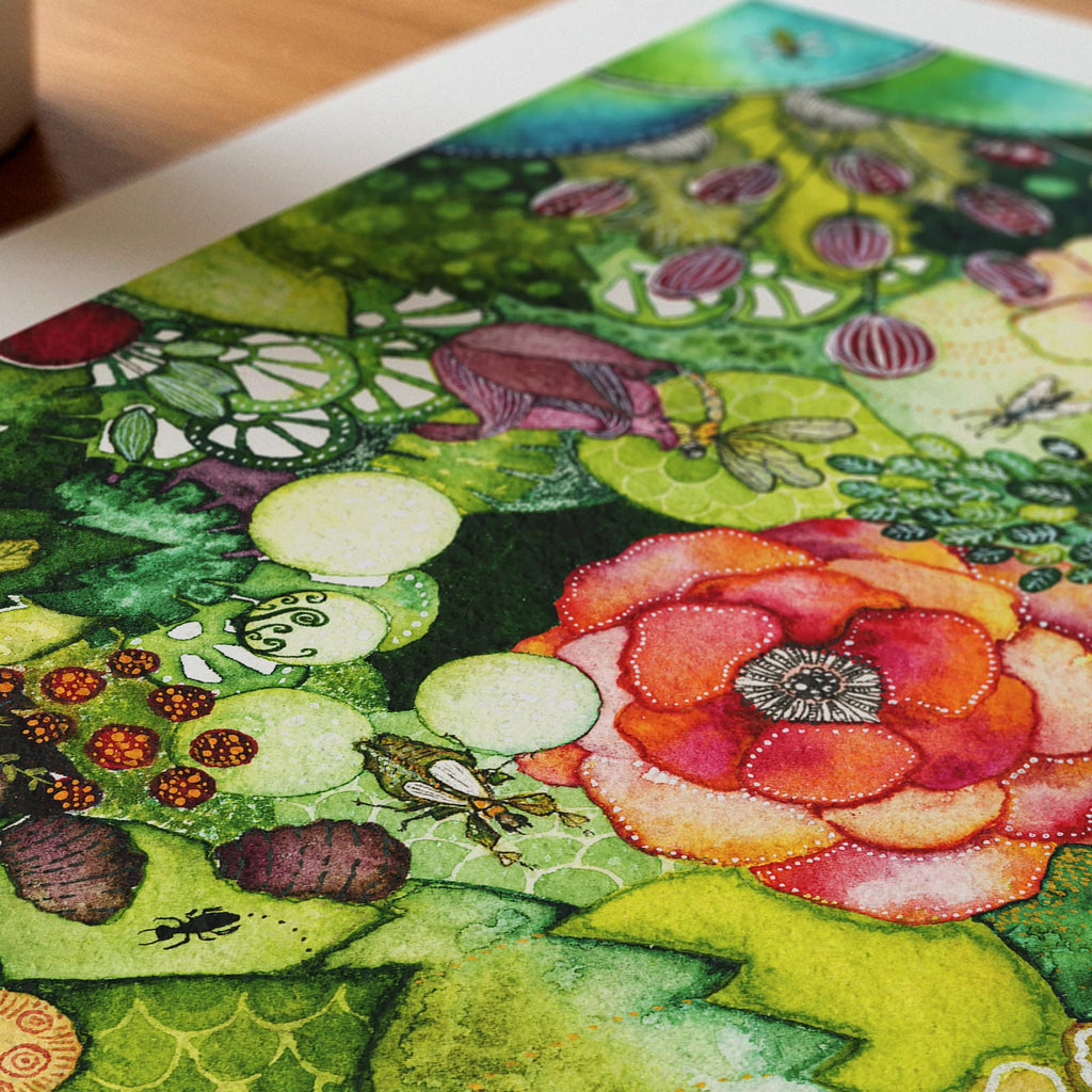 Close-up detail of the Green Lush fine art print on textured Hahnemühle German Etching paper at an angle, sharp watercolour foreground with a coral rose, a bee, striped berries and fine white linework, by Léna Ruisz.