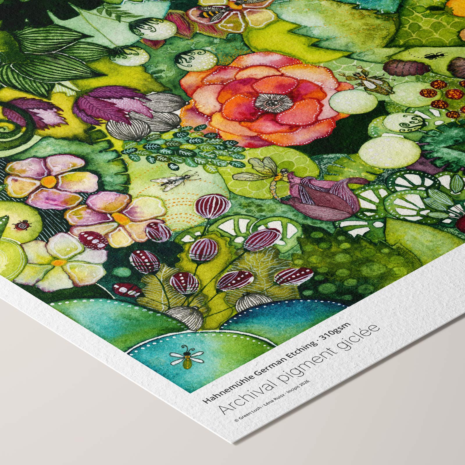Angled corner of the Green Lush fine art print on textured Hahnemühle German Etching paper, a lush watercolour thicket with a coral rose, bees and a dragonfly, beside printed paper credentials.