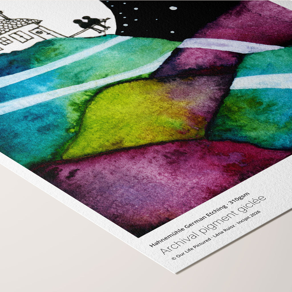 Angled corner of the Our Life Pictured fine art print on Hahnemühle German Etching paper, a tiny couple by a moonlit hilltop house above patchwork hills, beside printed paper credentials.