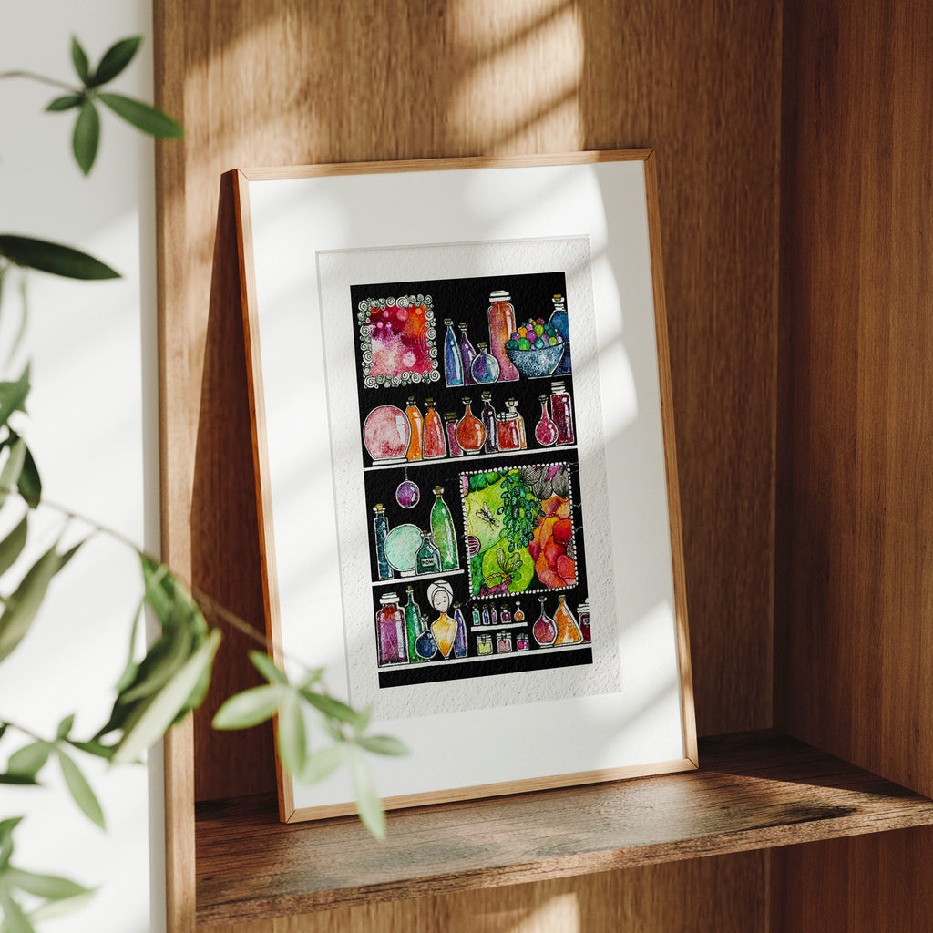 Framed Sorceress' Cabinet fine art print on a wooden shelf in dappled daylight, jewel-toned potion bottles and a placed green floral panel around a serene turbaned figure, by Léna Ruisz.
