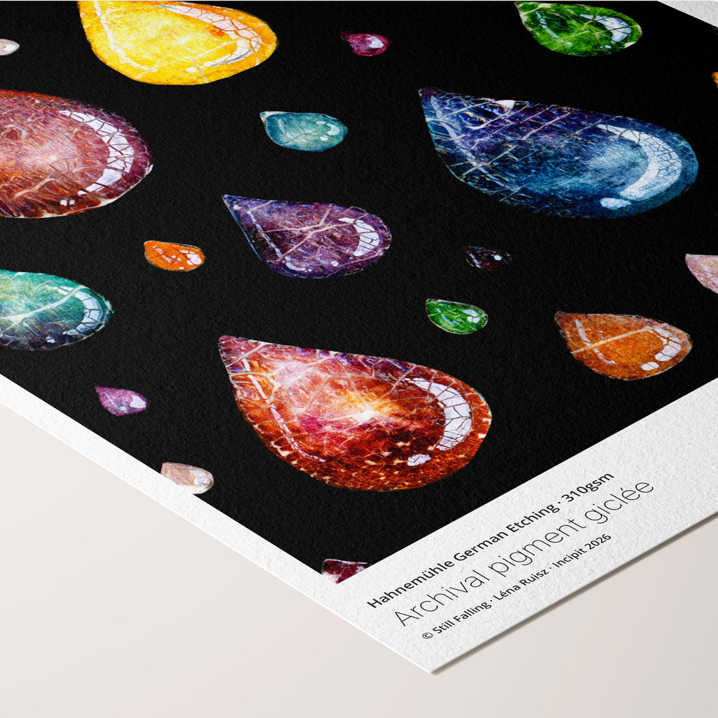 Angled corner of the Still Falling fine art print on Hahnemühle German Etching paper, translucent crackle-glazed raindrops in many colours falling through black, with printed paper credentials.